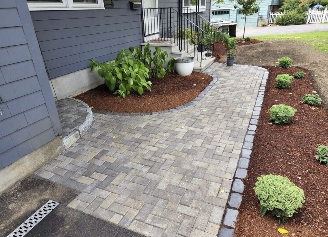 Professional concrete walkway installation with decorative pavers in Vero Beach, FL